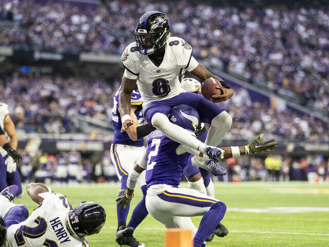 MINNEAPOLIS, MINNESOTA - NOVEMBER 9: Lamar Jackson #8 of the Baltimore Ravens hurdles over Isaiah Rodgers #2 of the Minnesota Vikings during an NFL football game at U.S. Bank Stadium on November 09, 2025 in Minneapolis, Minnesota.