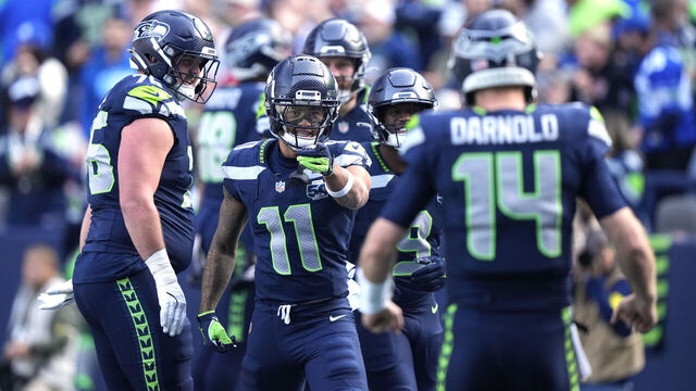 SEATTLE, WASHINGTON - NOVEMBER 09: Jaxon Smith-Njigba #11 and Sam Darnold #14 of the Seattle Seahawks celebrate after Smith-Njigba's receiving touchdown against the Arizona Cardinals in the first quarter of a game at Lumen Field on November 09, 2025 in Seattle, Washington.