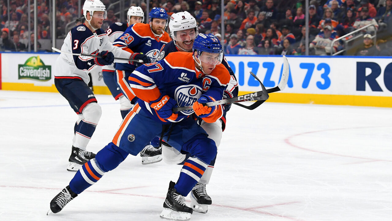EDMONTON, CANADA - NOVEMBER 10: Connor McDavid #97 of the Edmonton Oilers battles for the puck against Zach Werenski #8 of the Columbus Blue Jackets during the second period of the game at Rogers Place on November 10, 2025, in Edmonton, Alberta, Canada.