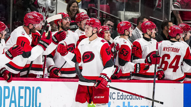 RALEIGH, NORTH CAROLINA - NOVEMBER 8: Charles Alexis Legault #62 of the Carolina Hurricanes high-fives his teammates after scoring his first career NHL goal in the third period of a game against the Buffalo Sabres at Lenovo Center on November 8, 2025 in Raleigh, North Carolina.