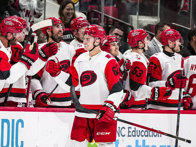 RALEIGH, NORTH CAROLINA - NOVEMBER 8: Charles Alexis Legault #62 of the Carolina Hurricanes high-fives his teammates after scoring his first career NHL goal in the third period of a game against the Buffalo Sabres at Lenovo Center on November 8, 2025 in Raleigh, North Carolina.