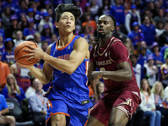 GAINESVILLE, FLORIDA - NOVEMBER 11: Xaivian Lee #1 of the Florida Gators drives to the basket against Robert McCray V #6 of the Florida State Seminoles during the first half of a game at the Stephen C. O'Connell Center on November 11, 2025 in Gainesville, Florida.