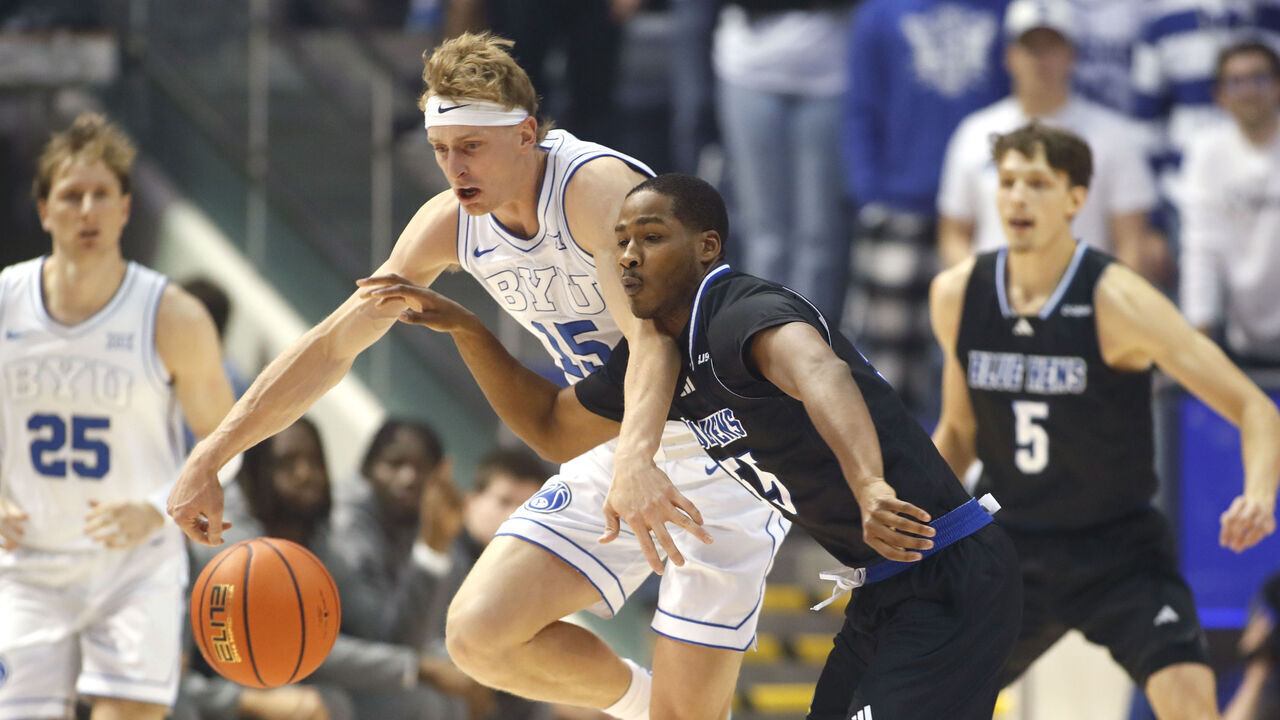 PROVO, UT - NOVEMBER 11: Jameel Brown #55 of the Delaware Blue Hens knocks the ball away from Richie Saunders #15 of the Brigham Young Cougars during the first half at the Marriott Center on November 11, 2025 in Provo, Utah.