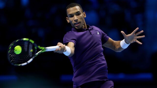 TURIN, ITALY - NOVEMBER 12: Felix Auger-Aliassime of Canada plays a forehand against Ben Shelton of United States during their Round Robin Singles match on day four of the Nitto ATP Finals 2025 at Inalpi Arena on November 12, 2025 in Turin, Italy.