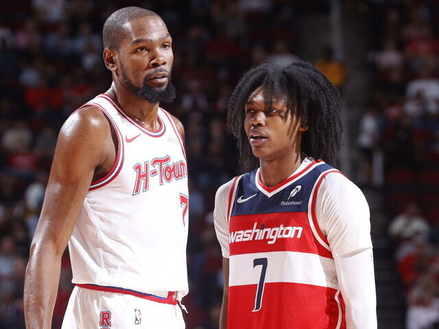 HOUSTON, TX - NOVEMBER 12: Kevin Durant #7 of the Houston Rockets and Bub Carrington #7 of the Washington Wizards looks on during the game on November 12, 2025 at the Toyota Center in Houston, Texas. Mandatory Copyright Notice: Copyright 2025 NBAE