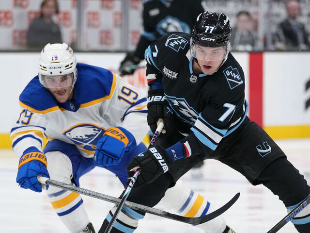 SALT LAKE CITY, UTAH - NOVEMBER 12: JJ Peterka #77 of the Utah Mammoth skates with the puck as Peyton Krebs #19 and Beck Malenstyn #29 of the Buffalo Sabres defend in the third period of a game at Delta Center on November 12, 2025 in Salt Lake City, Utah.
