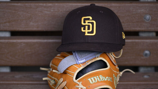 SAN DIEGO, CALIFORNIA - MAY 14: A detailed view of a San Diego Padres hat and Wilson glove before the game between the Padres and the Los Angeles Angels at Petco Park on May 14, 2025 in San Diego, California.