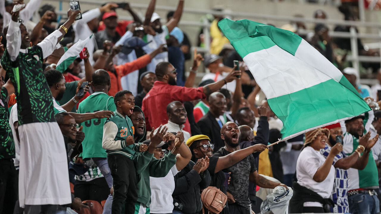 Nigerian supporters cheer after Nigeria's forward #20 Akor Adams scored their team's second goal during the FIFA World Cup 2026 Africa qualifiers group C match between Lesotho and Nigeria at the Peter Mokaba Stadium in Polokwane on October 10, 2025.