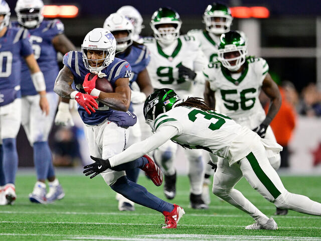 FOXBOROUGH, MASSACHUSETTS - NOVEMBER 13: TreVeyon Henderson #32 of the New England Patriots is pursued by Ja'Sir Taylor #36 of the New York Jets during the first half at Gillette Stadium on November 13, 2025 in Foxborough, Massachusetts.