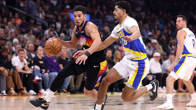 PHOENIX, ARIZONA - NOVEMBER 13: Devin Booker #1 of the Phoenix Suns drives to the basket against Ben Sheppard #26 of the Indiana Pacers during the first half at Mortgage Matchup Center on November 13, 2025 in Phoenix, Arizona.