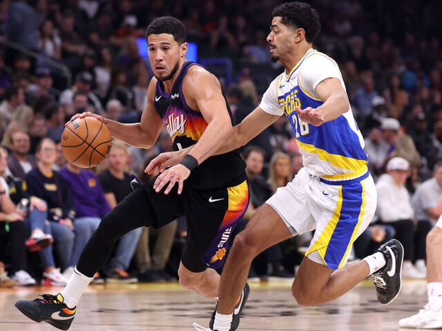 PHOENIX, ARIZONA - NOVEMBER 13: Devin Booker #1 of the Phoenix Suns drives to the basket against Ben Sheppard #26 of the Indiana Pacers during the first half at Mortgage Matchup Center on November 13, 2025 in Phoenix, Arizona.