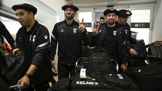 Palestinian national football team members wear the traditional Basque "txapela" (beret) as they arrive at Bilbao airport ahead of their friendly match against the Basque national team in Bilbao on November 11, 2025. On a "mission" in Spain, Palestinian national team coach Ehab Abu Jazar and his players will play symbolic friendlies against the Basque Country and Catalan national teams in the hopes of working towards safety and freedom for their people.