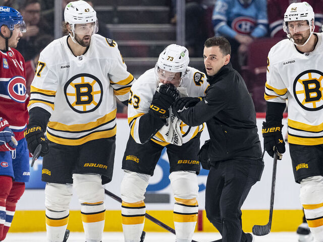 MONTREAL, CANADA- NOVEMBER 15: Charlie McAvoy #73 of the Boston Bruins exits the ice with a medical staff after being hit to the face by a puck during the second period of the NHL regular season game between the Montreal Canadiens and the Boston Bruins at the Bell Centre on November 15, 2025 in Montreal, Quebec, Canada.