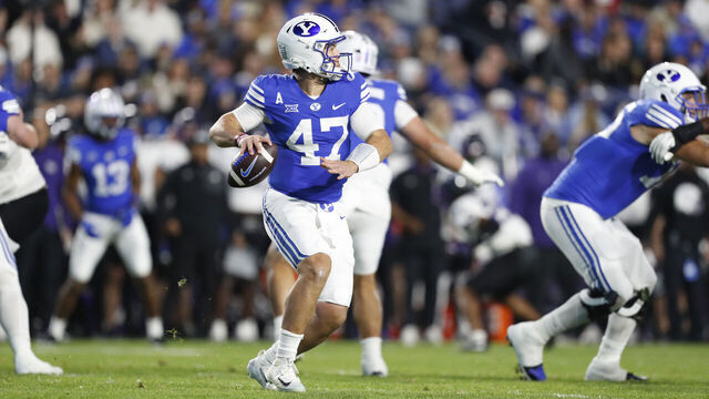 PROVO, UT - NOVEMBER 15: Bear Bachmeier #47 of the Brigham Young Cougars rolls out of the pocket to throw a pass against the Texas Christian University Horned Frogs during the first half of their game at LaVell Edwards Stadium on November 15, 2025 in Provo, Utah.