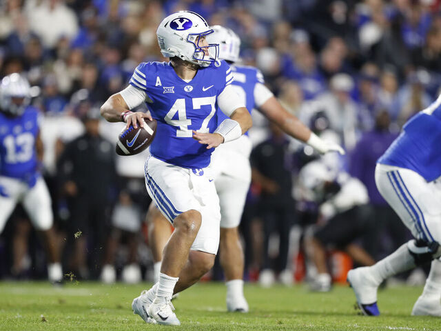 PROVO, UT - NOVEMBER 15: Bear Bachmeier #47 of the Brigham Young Cougars rolls out of the pocket to throw a pass against the Texas Christian University Horned Frogs during the first half of their game at LaVell Edwards Stadium on November 15, 2025 in Provo, Utah.