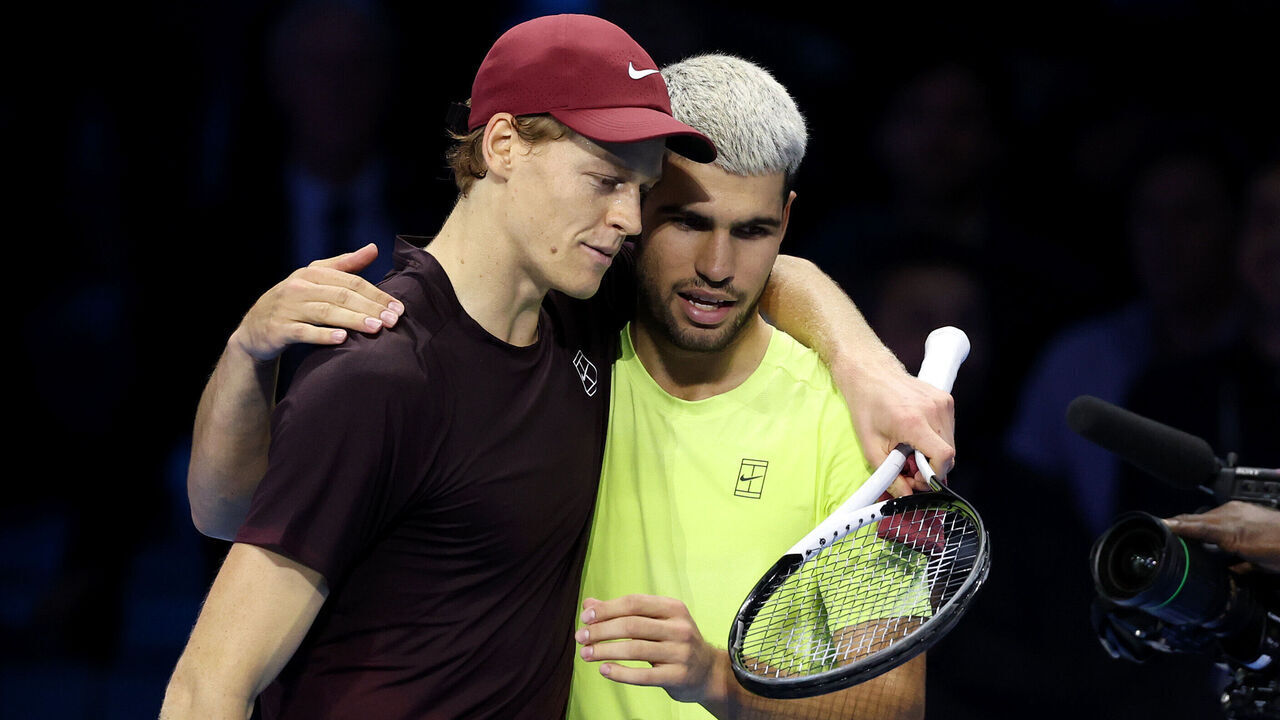 TURIN, ITALY - NOVEMBER 16: Jannik Sinner of Italy hugs Carlos Alcaraz of Spain following the Men's Singles Final on day eight of the Nitto ATP Finals 2025 at Inalpi Arena on November 16, 2025 in Turin, Italy.