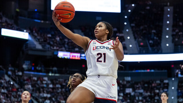 HARTFORD, CONNECTICUT - NOVEMBER 16: Sarah Strong #21 of the Connecticut Huskies drives to the rim against Jaloni Cambridge #22 of the Ohio State Buckeyes during the second half of an NCAA women's basketball game at PeoplesBank Arena on November 16, 2025 in Hartford, Connecticut.