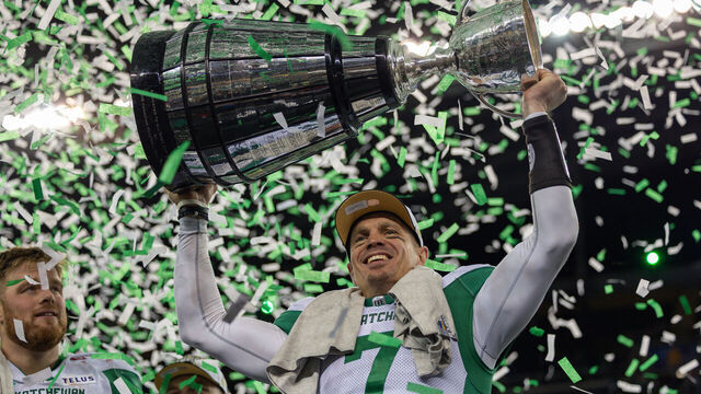 WINNIPEG, CANADA - NOVEMBER 16: Trevor Harris #7 of the Saskatchewan Roughriders hoists the Grey Cup after the 112th Grey Cup game between the Montreal Alouettes and Saskatchewan Roughriders at Princess Auto Stadium on November 16, 2025 in Winnipeg, Canada.