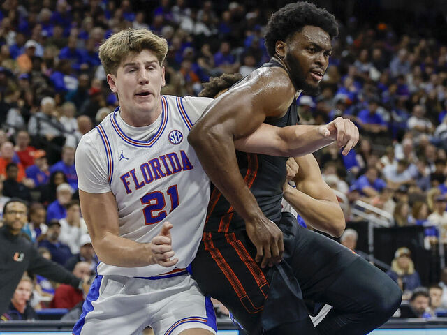 JACKSONVILLE, FL - NOVEMBER 16: Florida Gators forward Alex Condon (21) battles Miami (FL) Hurricanes center Ernest Udeh Jr. (8) during the game between the Miami Hurricanes and the Florida Gators on November 16, 2025 at Jacksonville Veterans Memorial Arena in Jacksonville, Fl.
