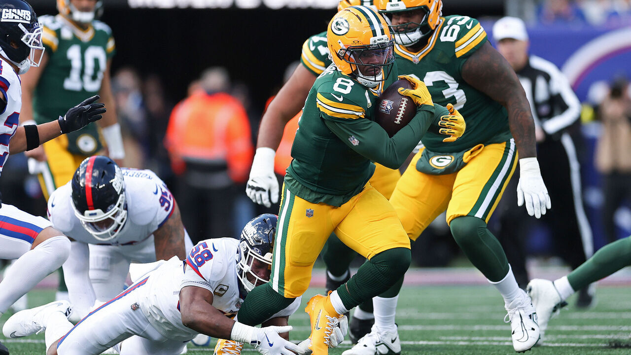 EAST RUTHERFORD, NEW JERSEY - NOVEMBER 16: Josh Jacobs #8 of the Green Bay Packers is tackled during the first quarter against the New York Giants at MetLife Stadium on November 16, 2025 in East Rutherford, New Jersey.