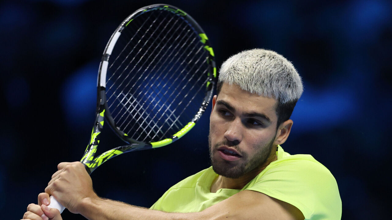 TURIN, ITALY - NOVEMBER 16: Carlos Alcaraz of Spain plays a backhand during the Men's Singles Final against Jannik Sinner of Italy on day eight of the Nitto ATP Finals 2025 at Inalpi Arena on November 16, 2025 in Turin, Italy.