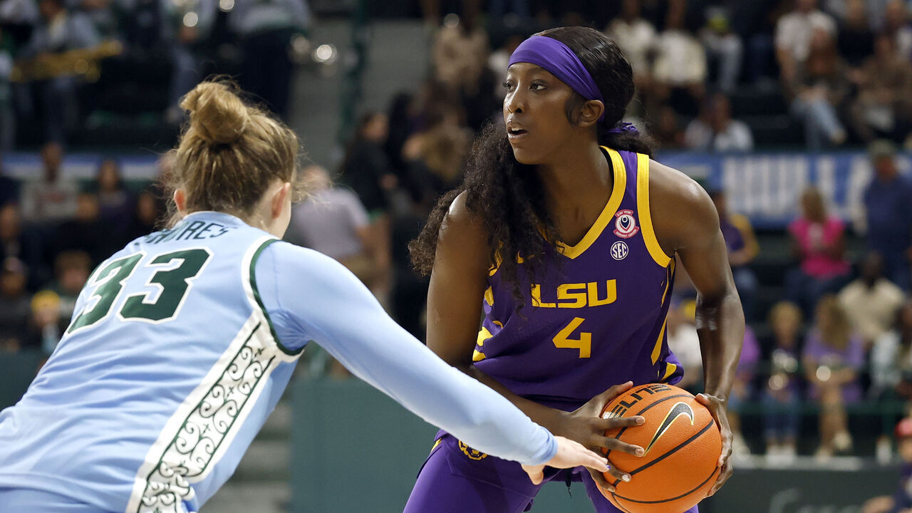 NEW ORLEANS, LOUISIANA - NOVEMBER 17: Flau'Jae Johnson #4 of the LSU Tigers is defended by Sadie Shores #33 of the Tulane Green Wave during the first half of the game at Avron B. Fogelman Arena on November 17, 2025 in New Orleans, Louisiana.