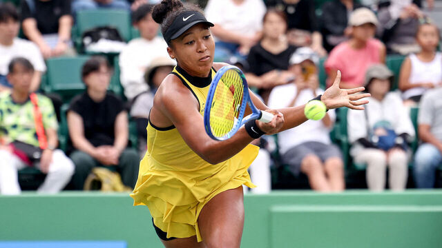 Japan's Naomi Osaka hits a return to Netherlands' Suzan Lamens in their women's singles match at the Japan Open tennis tournament in Osaka on October 15, 2025.