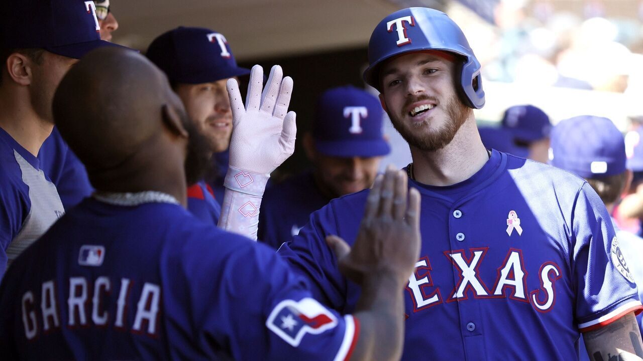 DETROIT, MI - MAY 11: Jonah Heim #28 of the Texas Rangers celebrates with Adolis García #53 in the dugout after hitting a solo home run against the Detroit Tigers during the eighth inning at Comerica Park on May 11, 2025 in Detroit, Michigan.