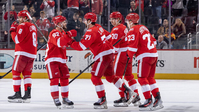 DETROIT, MICHIGAN - NOVEMBER 18: Dylan Larkin #71 of the Detroit Red Wings scores an empty net goal and his 600th NHL point against the Seattle Kraken and celebrates with Alex Debrincat #93, Albert Johansson #20 and Lucas Raymond #23 during the third period at Little Caesars Arena on November 18, 2025 in Detroit, Michigan. Detroit defeated Seattle 4-2.