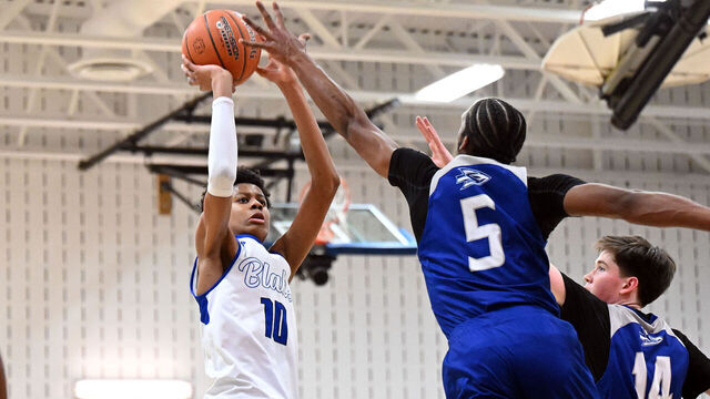 SILVER SPRING, MD- JANUARY 5, 2024: Blake player Babatunde Oladotun (left)shoots over Sherwood's Erin Thompson (right) during the Boys basketball game between Blake High School vs Sherwood High School at Blake High School in Silver Spring, MD on January 5, 2024.