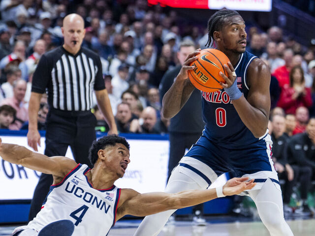 STORRS, CONNECTICUT - NOVEMBER 19: Dwayne Koroma #4 of the Connecticut Huskies goes to the floor defending against Jaden Bradley #0 of the Arizona Wildcats in the first half at Harry A. Gampel Pavilion on November 19, 2025 in Storrs, Connecticut.
