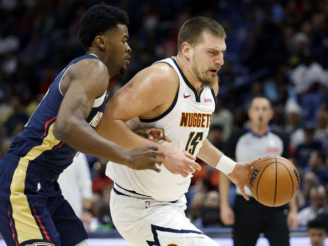 NEW ORLEANS, LOUISIANA - NOVEMBER 19: Nikola Jokic #15 of the Denver Nuggets is defended by Yves Missi #21 of the New Orleans Pelicans during the first half at Smoothie King Center on November 19, 2025 in New Orleans, Louisiana.