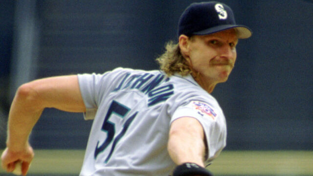 MILWAUKEE - CIRCA 1997: Randy Johnson #51 of the Seattle Mariners pitches during an MLB game at County Stadium in Milwaukee, Wisconsin. Johnson played for 22 season with 6 different and was a 10-time All-Star,a 5-time Cy Young Award winner and was elected to the Baseball Hall of Fame in 2015.