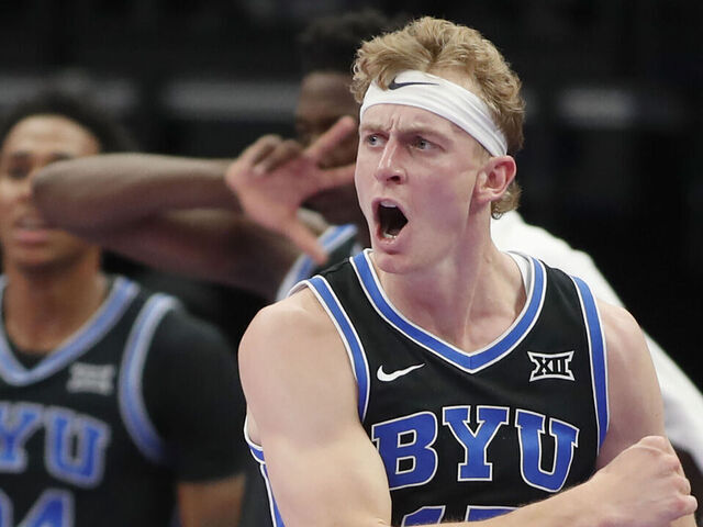 SALT LAKE CITY, UT - NOVEMBER 21: Richie Saunders #15 of the Brigham Young Cougars reacts after sinking a three point basket against the Wisconsin Badgers during the second half of their Bad Boys Mowers Series game at the Delta Center on November 21, 2025 in Salt Lake City, Utah.
