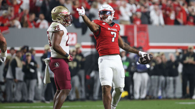 RALEIGH, NC - NOVEMBER 21: Justin Joly #7 of the North Carolina State Wolfpack signals the first down during the college football game between the North Carolina State Wolfpack and the Florida State Seminoles on November 21, 2025 at Carter-Finley Stadium in Raleigh, NC.