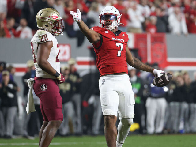 RALEIGH, NC - NOVEMBER 21: Justin Joly #7 of the North Carolina State Wolfpack signals the first down during the college football game between the North Carolina State Wolfpack and the Florida State Seminoles on November 21, 2025 at Carter-Finley Stadium in Raleigh, NC.
