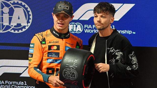 LAS VEGAS, NEVADA - NOVEMBER 21: Pole position qualifier Lando Norris of Great Britain and McLaren receives his Pirelli Pole Position award from Louis Tomlinson during qualifying ahead of the F1 Grand Prix of Las Vegas at Las Vegas Strip Circuit on November 21, 2025 in Las Vegas, Nevada.