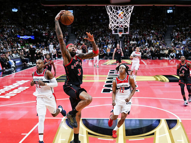 TORONTO, CANADA - NOVEMBER 21: Brandon Ingram #3 of the Toronto Raptors dunks against Tre Johnson #12 and Khris Middleton #22 of the Washington Wizards during the first half of their basketball game at the Scotiabank Arena on November 21, 2025 in Toronto, Ontario, Canada. NOTE TO USER: User expressly acknowledges and agrees that, by downloading and/or using this Photograph, user is consenting to the terms and conditions of the Getty Images License Agreement.