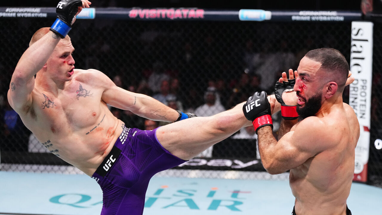 DOHA, QATAR - NOVEMBER 22: (L-R) Ian Machado Garry of Ireland kicks Belal Muhammad in a welterweight fight during the UFC Fight Night event at ABHA Arena on November 22, 2025 in Doha, Qatar.