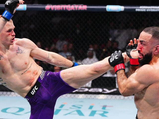 DOHA, QATAR - NOVEMBER 22: (L-R) Ian Machado Garry of Ireland kicks Belal Muhammad in a welterweight fight during the UFC Fight Night event at ABHA Arena on November 22, 2025 in Doha, Qatar.