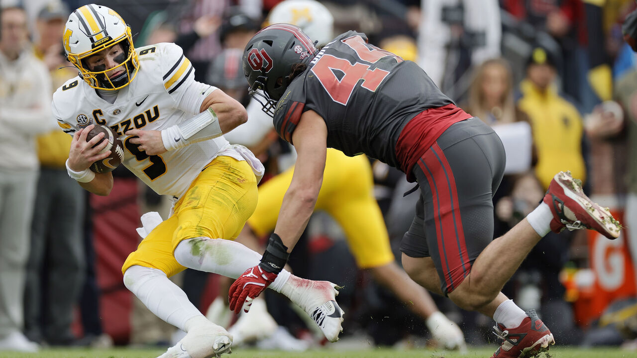 NORMAN, OKLAHOMA - NOVEMBER 25: Defensive lineman Taylor Wein #44 of the Oklahoma Sooners sacks quarterback Beau Pribula #9 of the Missouri Tigers for a loss of nine yards after picking up his own fumble at the four-yard line at Gaylord Family Oklahoma Memorial Stadium on November 22, 2025 in Norman, Oklahoma.