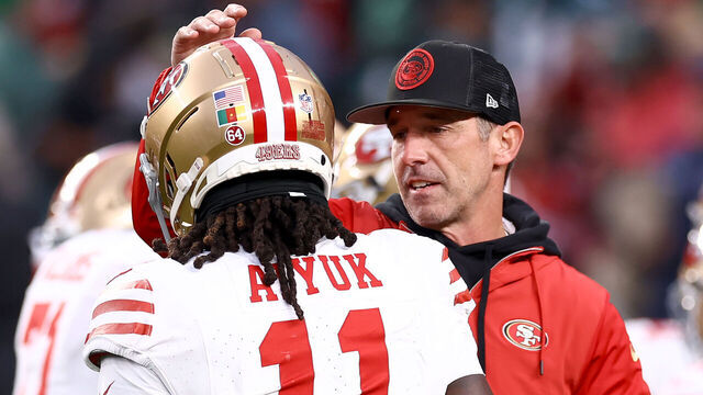 PHILADELPHIA, PENNSYLVANIA - DECEMBER 03: Head coach Kyle Shanahan of the San Francisco 49ers speaks with Brandon Aiyuk #11 prior to the game against the Philadelphia Eagles at Lincoln Financial Field on December 03, 2023 in Philadelphia, Pennsylvania.