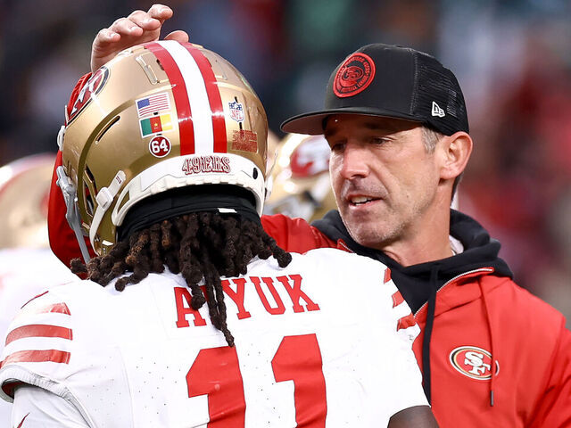 PHILADELPHIA, PENNSYLVANIA - DECEMBER 03: Head coach Kyle Shanahan of the San Francisco 49ers speaks with Brandon Aiyuk #11 prior to the game against the Philadelphia Eagles at Lincoln Financial Field on December 03, 2023 in Philadelphia, Pennsylvania.