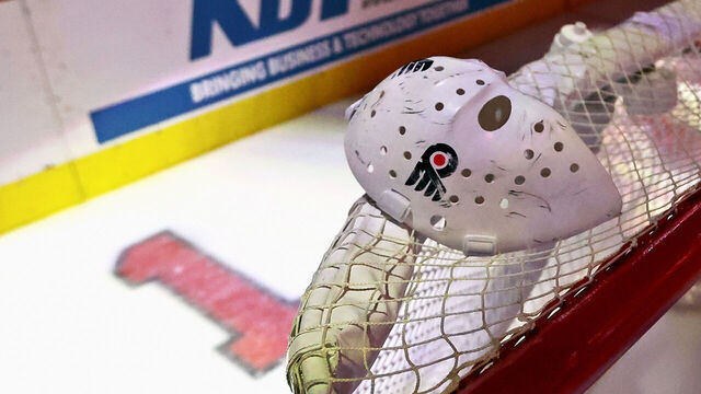 PHILADELPHIA, PENNSYLVANIA - NOVEMBER 22: The mask of Hockey Hall of Fame member and former member of the Philadelphia Flyers Bernie Parent is pictured on top of the net during a pregame ceremony celebrating his life at the Xfinity Mobile Arena on November 22, 2025 in Philadelphia, Pennsylvania. Parent passed away on September 21, 2025.