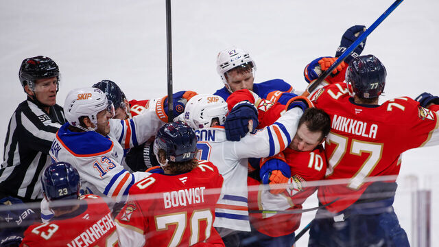 SUNRISE, FL - NOVEMBER 22: Edmonton Oilers players and Florida Panthers defenseman come together and fight on the boards in the third period during a NHL game between the Edmonton Oilers and the Florida Panthers on November 22, 2025 at Amerant Bank Arena in Sunrise, FL.