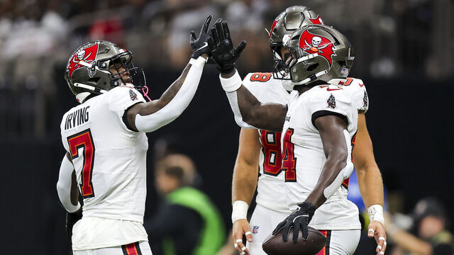 NEW ORLEANS, LOUISIANA - OCTOBER 13: Chris Godwin #14 of the Tampa Bay Buccaneers (L) celebrates with teammate Bucky Irving #7 (R) after scoring a touchdown against the New Orleans Saints during the first quarter of the game at Caesars Superdome on October 13, 2024 in New Orleans, Louisiana.