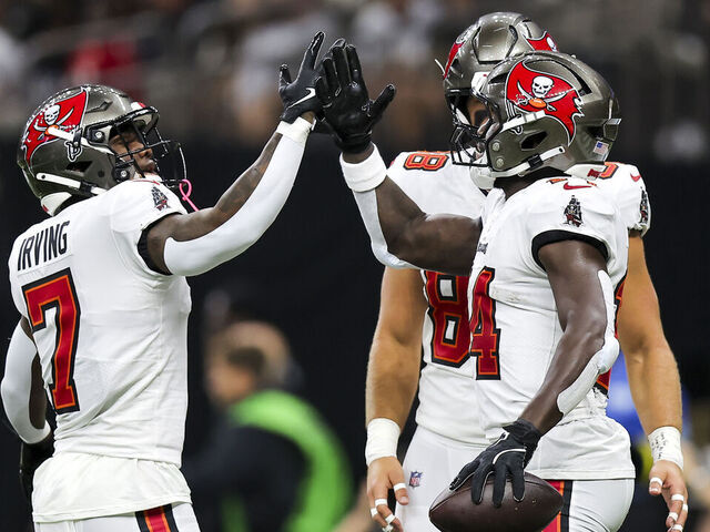 NEW ORLEANS, LOUISIANA - OCTOBER 13: Chris Godwin #14 of the Tampa Bay Buccaneers (L) celebrates with teammate Bucky Irving #7 (R) after scoring a touchdown against the New Orleans Saints during the first quarter of the game at Caesars Superdome on October 13, 2024 in New Orleans, Louisiana.