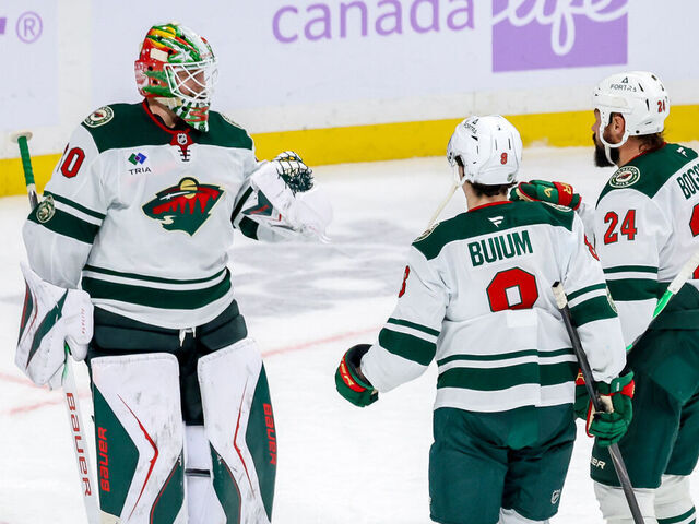WINNIPEG, CANADA - NOVEMBER 23: Goaltender Jesper Wallstedt #30, Zeev Buium #8 and Zach Bogosian #24 of the Minnesota Wild celebrate a 3-0 shutout victory over the Winnipeg Jets at the Canada Life Centre on November 23, 2025 in Winnipeg, Manitoba, Canada.