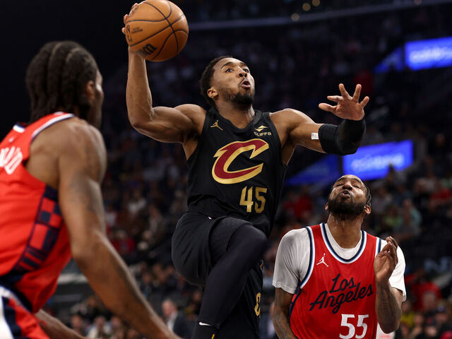 INGLEWOOD, CALIFORNIA - MARCH 18: Donovan Mitchell #45 of the Cleveland Cavaliers drives to the basket against Kawhi Leonard #2 and Derrick Jones Jr. #55 of the Los Angeles Clippers during the second quarter at Intuit Dome on March 18, 2025 in Inglewood, California.