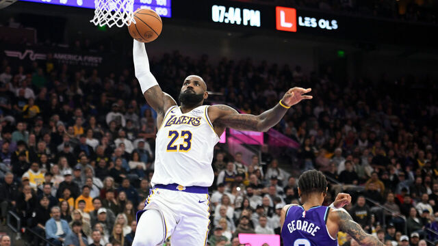 SALT LAKE CITY, UTAH - NOVEMBER 23: LeBron James #23 of the Los Angeles Lakers dunks in front of Keyonte George #3 of the Utah Jazz during the second half of a game at Delta Center on November 23, 2025 in Salt Lake City, Utah.